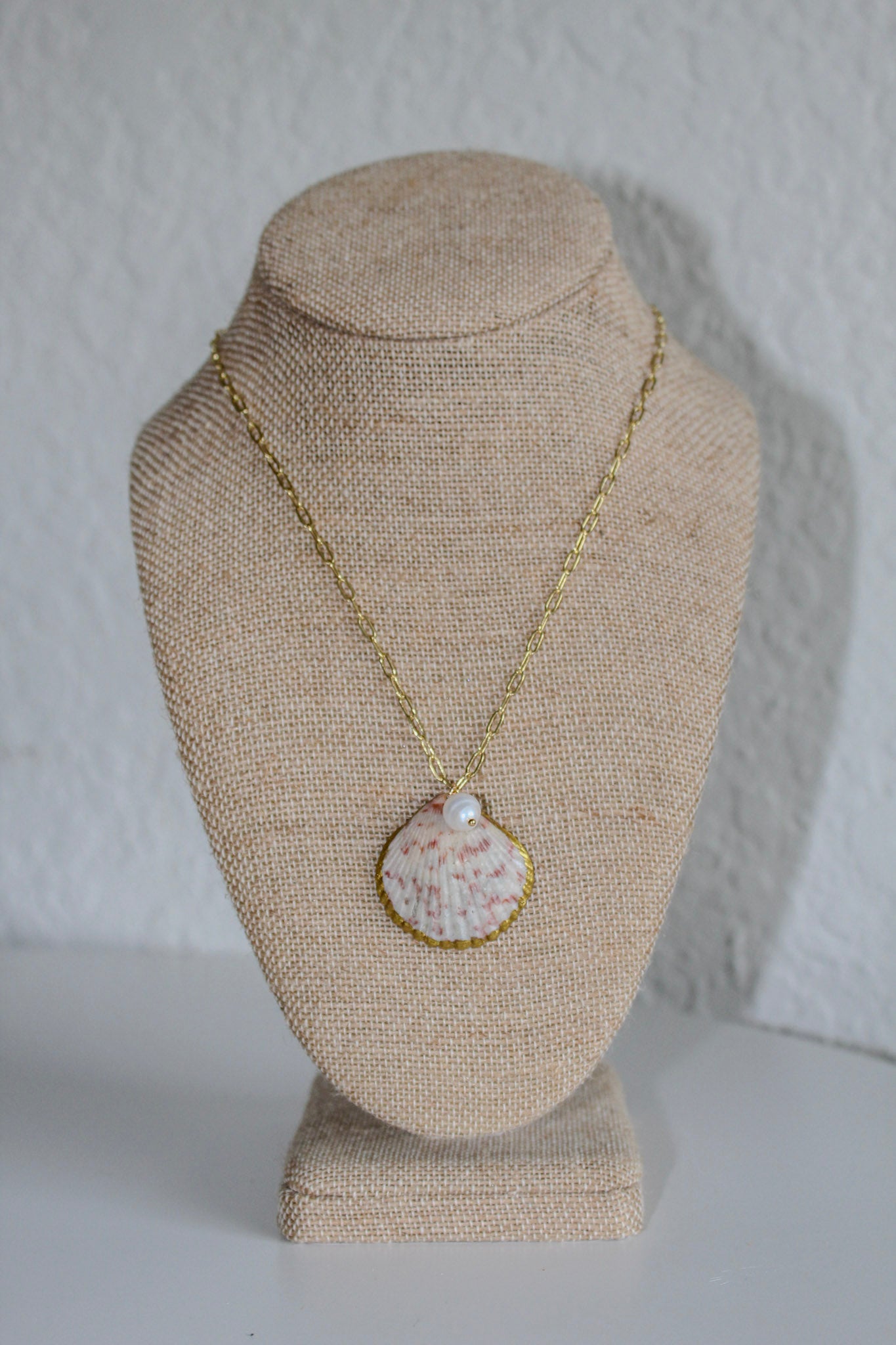 Large scallop shell with pearl necklace