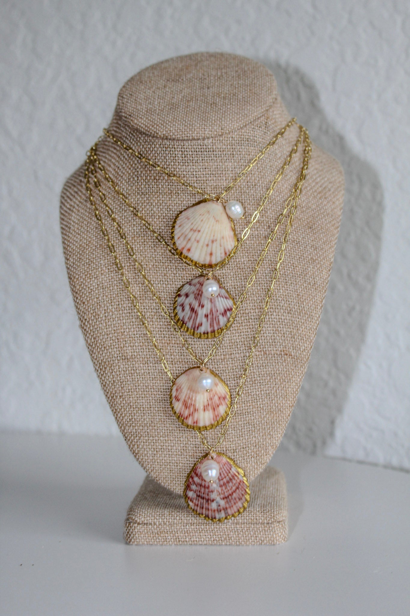 Large scallop shell with pearl necklace